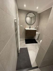 a bathroom with a sink and a mirror at Apartment City Center Gouda in Gouda