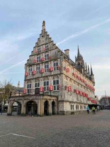 a large building with red decorations on it at Apartment City Center Gouda in Gouda