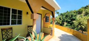 an outside view of a house with a porch at Papaya Grove Mountainview Condos in Hope