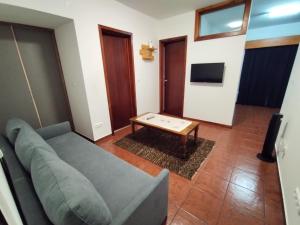 a living room with a couch and a coffee table at Apartamentos Lisboa in Vila do Porto