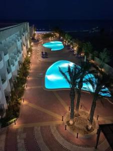 an overhead view of a swimming pool at night at Ferienwohnung in Cecelia Resort in Hurghada