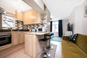 a kitchen with a couch and a counter in a room at spacious flat in london in London