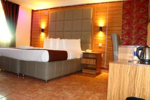 um quarto de hotel com uma cama grande num quarto em Presken K-ONE em Ikeja