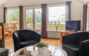 a living room with two chairs and a television at Awesome Apartment In Dirdal With 2 Bedrooms And Wifi in Dirdal