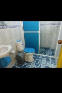 a bathroom with a toilet and a sink at Casa el remanso in Acacías