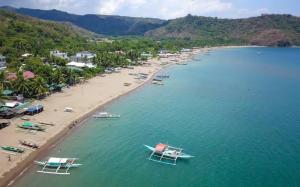 an aerial view of a beach with boats in the water at TINA TRANSIENT HOME in Nasugbu