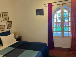 Giường trong phòng chung tại Chez Olivier - Île de Gorée