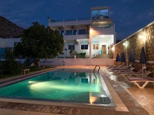 a villa with a swimming pool at night at Maison D'hôtes Ait Mouli in Bzou