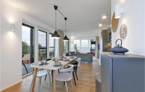 a dining room and living room with a table and chairs at Beach Front Apartment in Lembruch
