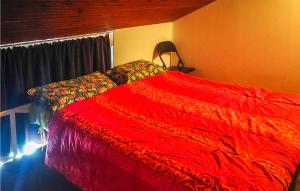 a bedroom with a bed with a red blanket at 2 Bedroom Cozy Apartment In San Massimo in San Massimo