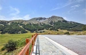 a road with a fence and mountains in the background at 2 Bedroom Cozy Apartment In San Massimo in San Massimo