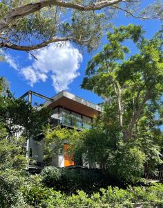 a house with a tree in front of it at Tranquil Garden Apartment with living room in Wollongong