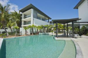 an image of a swimming pool in front of a house at Blue on Blue Studio Room 1322 in Nelly Bay