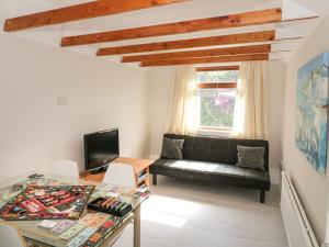 a living room with a couch and a table at Waters Edge in Stranraer