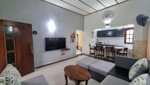 a living room with a couch and a table at Ralph recedency in Kochchikade