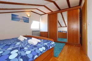 a bedroom with a bed with towels on it at Villa Dalmatia in Zadar