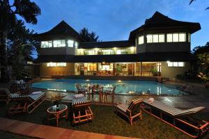 a house with a swimming pool in front of it at Mimosa Court Apartments in Nairobi