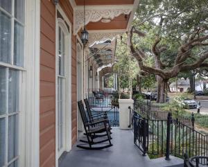 a porch with two rocking chairs on a house at Beautifully Updated New Orleans House *sleeps 6* in New Orleans