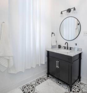 a bathroom with a sink and a mirror at Beautifully Updated New Orleans House *sleeps 6* in New Orleans