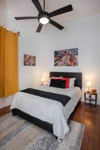 a bedroom with a large bed with a ceiling fan at Beautifully Updated New Orleans House *sleeps 6* in New Orleans