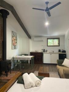 - un salon avec une table et un ventilateur de plafond dans l'établissement Holly House Garden Studio, à Moyhu