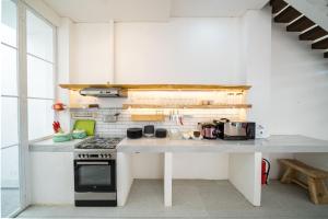 a kitchen with a stove and a counter top at IMAH DHARMA in Bandung