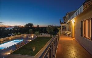 a balcony of a house with a swimming pool at One-Bedroom Apartment In Vrsar in Vrsar +22 photos
