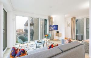 a living room with a couch and a large window at Cozy Apartment In Lembruchdümmer See in Lembruch