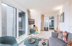 a living room with a couch and chairs and a table at Cozy Apartment In Lembruchdümmer See in Lembruch