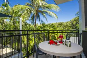 a table on a balcony with a view of the ocean at Magnetic North Apartment 1 in Arcadia