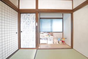 Postel nebo postele na pokoji v ubytování 釣りスポットの松部漁港まで徒歩1分-ファミリー&釣り好きに大人気の宿