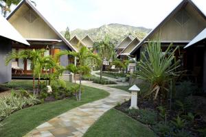 a courtyard of a resort with a path and plants at Pure Magnetic Villa 6 in Nelly Bay