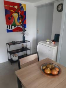uma sala com uma mesa com uma tigela de fruta em Chambre d'hôte Chez Josie em Beaucaire