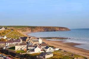 an aerial view of a beach with houses and the ocean at Cottage in Pwllheli