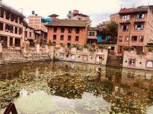 a body of water in a city with buildings at Bungamati Community Homestay in Chapagaon