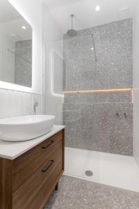 a bathroom with a sink and a glass shower at 40 Renshaw Apartments in Liverpool