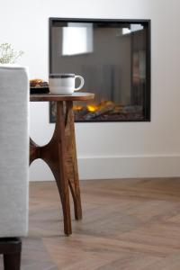 a coffee cup on a table in a living room with a fireplace at 40 Renshaw Apartments in Liverpool
