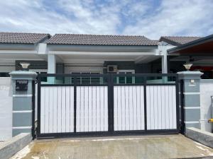 a gate in front of a house at M Guest House in Muar