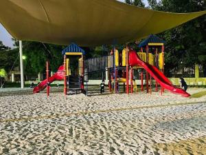 a playground in a park with a slide at Rayyan Stays in Dubai