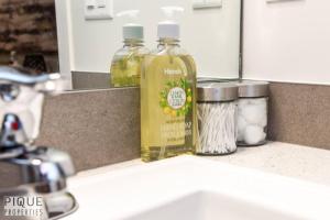 two bottles of liquid soap sitting on a kitchen counter at NEW Modern 2 Bedroom Suite, Complimentary Netflix, Sleeps 4 in Edmonton