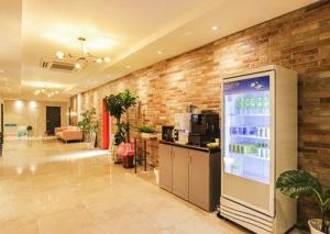 a lobby with a drink cooler and a brick wall at NO25 Hotel Ansan in Ansan