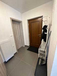 a hallway with a shopping cart and a door at APARTMA ALMA in Bovec