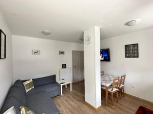a living room with a couch and a table at APARTMA ALMA in Bovec