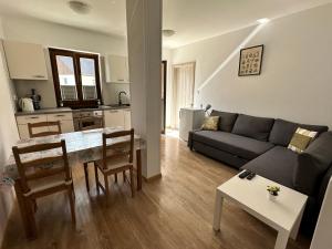 a living room with a couch and a table at APARTMA ALMA in Bovec