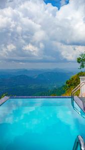 a swimming pool with a view of the mountains at Misty Hills Villa Kadugannawa in Kadugannawa