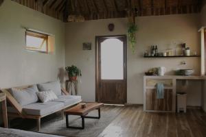 een woonkamer met een bank en een tafel bij Santai House in Tetebatu