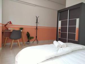 a bedroom with a bed with two pillows on it at Damansara Perdana 3BR for 3-7 Guest Near Ikea in Petaling Jaya