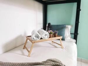 a bed with a wooden tray with towels on it at Damansara Perdana 3BR for 3-7 Guest Near Ikea in Petaling Jaya +45 photos