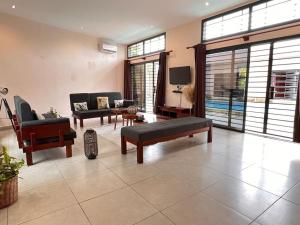 a living room with two couches and a tv at Villa Tiana - 3Bedroom Villa with private pool. in Kribi