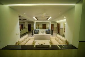 a living room with two couches and a table at Kyriad Prestige Ilkal in Ilkal